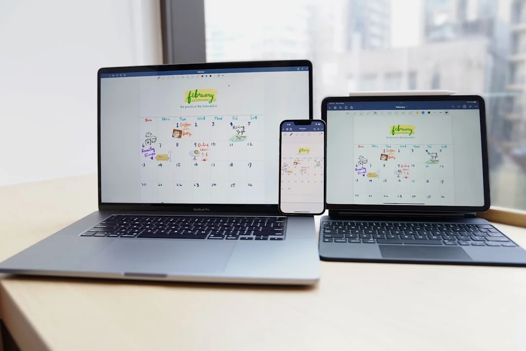 A clean and modern workspace featuring a laptop, tablet, smartphone, and monitor. Ideal for remote work and tech setups.